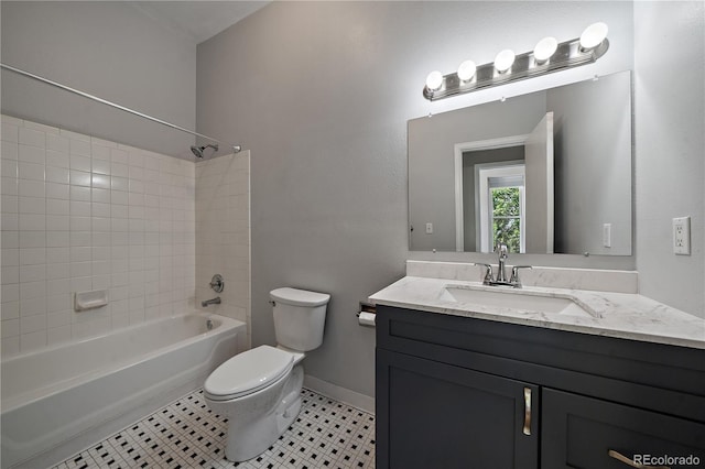 full bathroom featuring tile patterned flooring, vanity, tiled shower / bath combo, and toilet