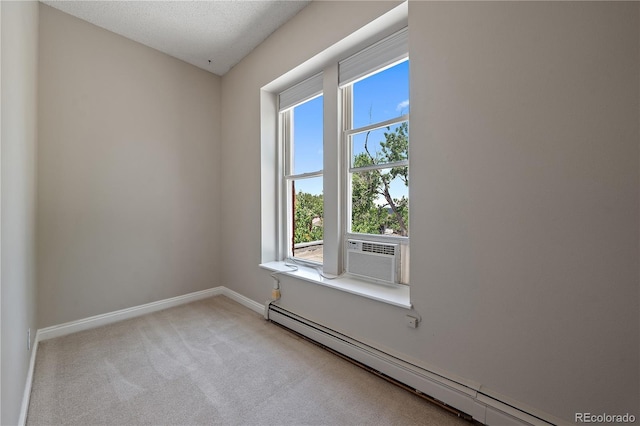 empty room featuring carpet flooring, a textured ceiling, a baseboard radiator, and cooling unit