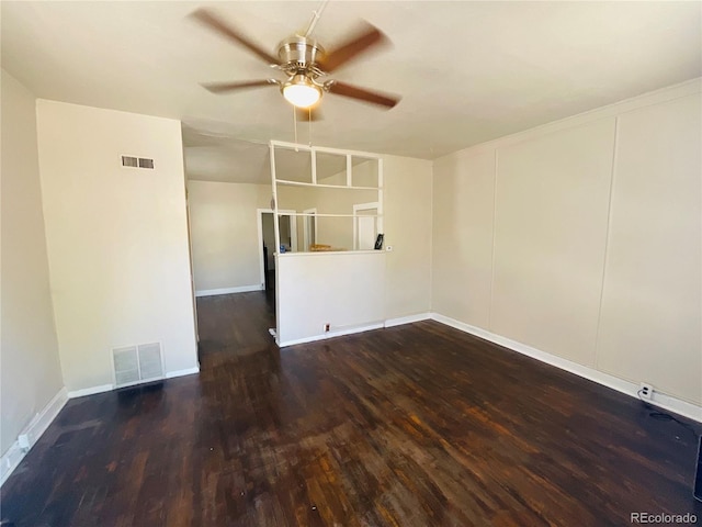 empty room with ceiling fan and dark hardwood / wood-style flooring