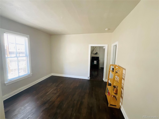 unfurnished room featuring dark wood-type flooring