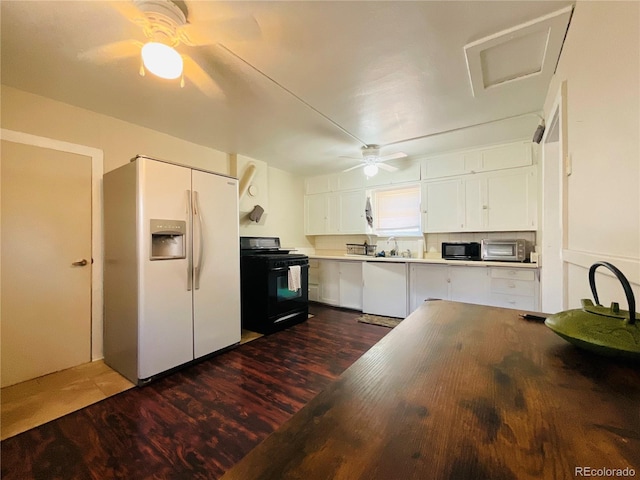 kitchen featuring black appliances, dark hardwood / wood-style flooring, white cabinets, and sink