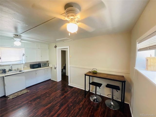 kitchen featuring dark hardwood / wood-style flooring, white cabinetry, ceiling fan, and sink