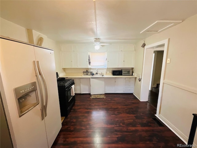 kitchen featuring black appliances, dark hardwood / wood-style floors, and white cabinetry