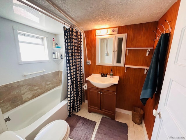 full bathroom featuring vanity, shower / tub combo with curtain, wooden walls, tile patterned flooring, and toilet