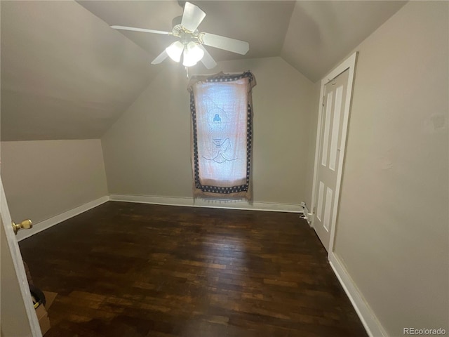 additional living space featuring vaulted ceiling, ceiling fan, and dark wood-type flooring