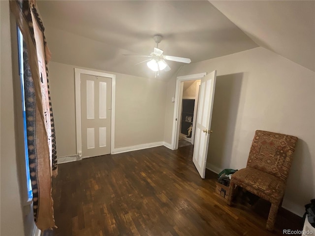 interior space featuring ceiling fan, dark wood-type flooring, and lofted ceiling