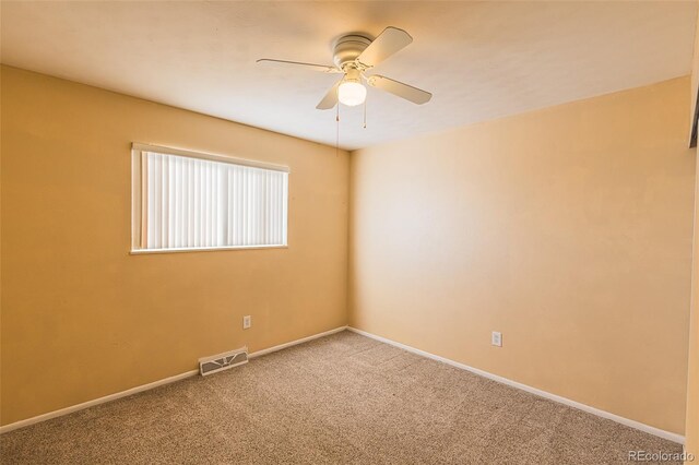 carpeted spare room featuring ceiling fan