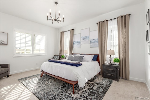 bedroom featuring baseboards, light colored carpet, and a chandelier