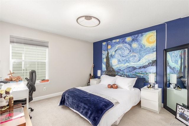 bedroom featuring light carpet and baseboards