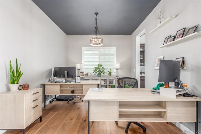 office with a notable chandelier and wood-type flooring