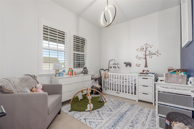 bedroom featuring light colored carpet and a crib