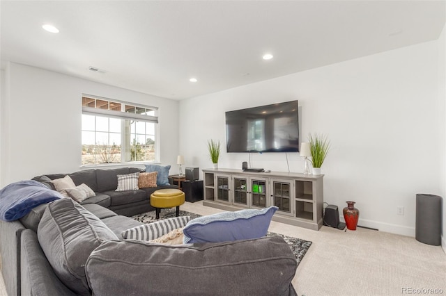 carpeted living area featuring recessed lighting, visible vents, and baseboards