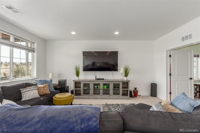 carpeted living area featuring visible vents, recessed lighting, and baseboards