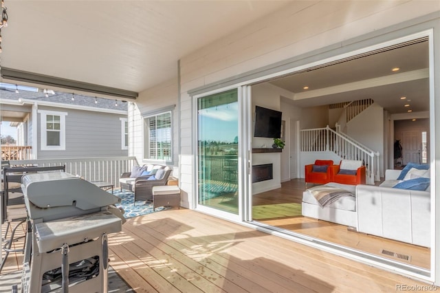 exterior space with an outdoor hangout area and a wooden deck