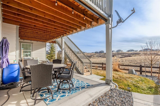 view of patio with stairs and outdoor dining area