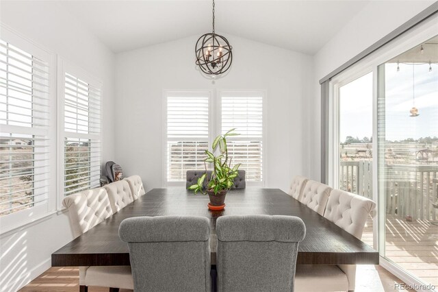 22773 E Narrowleaf Cir, Aurora, CO 80016 - dining space with a chandelier, healthy amount of natural light, vaulted ceiling, and wood finished floors