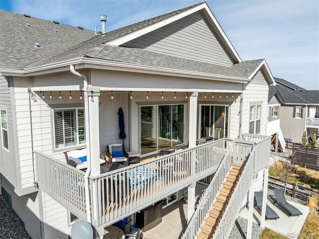 22773 E Narrowleaf Cir, Aurora, CO 80016 - back of property with a shingled roof, a deck, and stairway