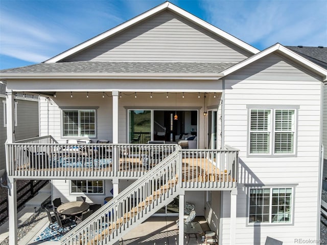 22773 E Narrowleaf Cir, Aurora, CO 80016 - back of property featuring stairs, a shingled roof, and a patio