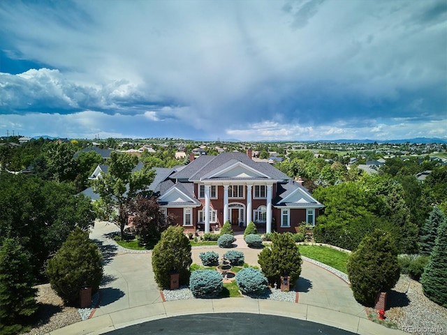 8717 Ridgepoint Dr, Castle Pines, CO 80108 - neoclassical home with curved driveway and a chimney