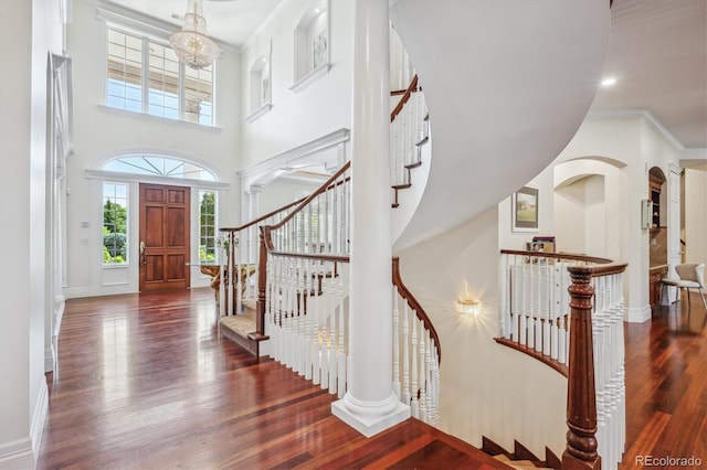 8717 Ridgepoint Dr, Castle Pines, CO 80108 - entryway with wood finished floors, a towering ceiling, and stairs