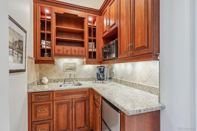 8717 Ridgepoint Dr, Castle Pines, CO 80108 - kitchen featuring stainless steel microwave, glass insert cabinets, decorative backsplash, light stone countertops, and refrigerator