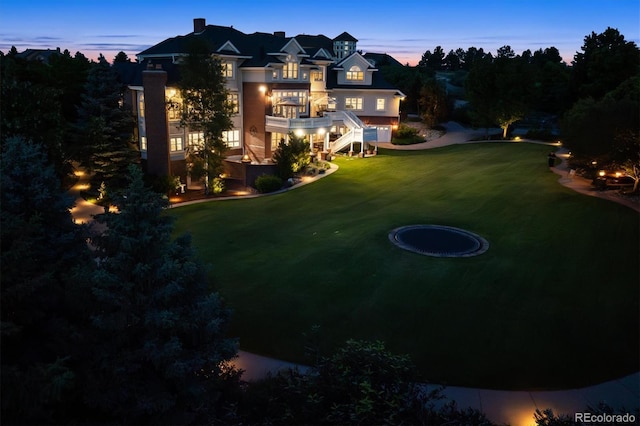8717 Ridgepoint Dr, Castle Pines, CO 80108 - yard at dusk featuring a lawn and stairs