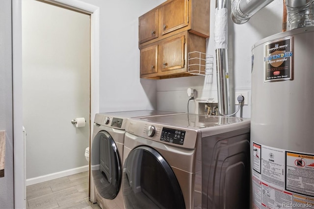 1799 S Lee St Unit B, Lakewood, CO 80232 - laundry room with gas water heater, washing machine and dryer, cabinet space, light wood finished floors, and baseboards