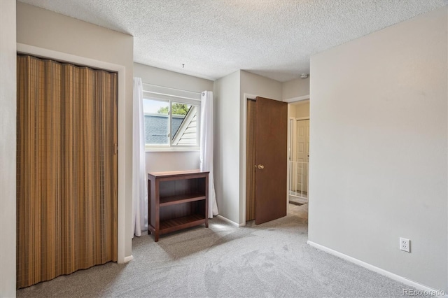 1799 S Lee St Unit B, Lakewood, CO 80232 - unfurnished bedroom featuring carpet flooring, a textured ceiling, baseboards, and two closets
