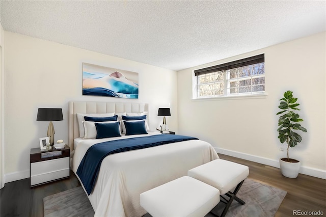 bedroom featuring a textured ceiling and dark hardwood / wood-style floors