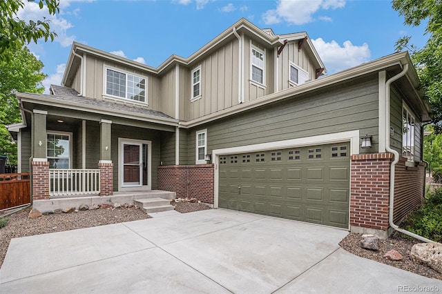 3389 Willowrun Dr, Castle Rock, CO 80109 - view of front of home featuring board and batten siding, driveway, a porch, and brick siding