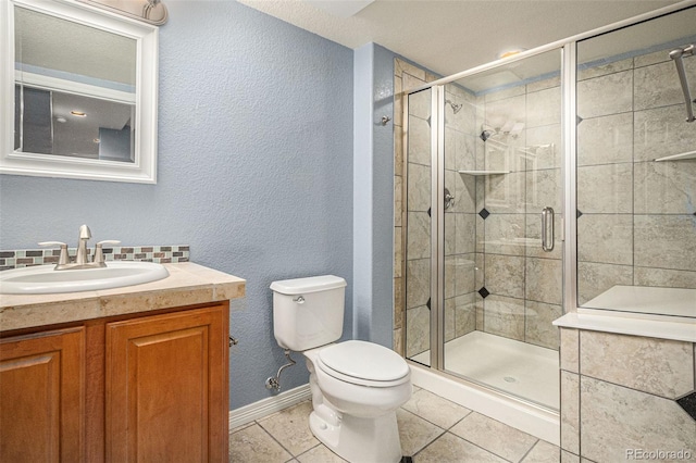 3389 Willowrun Dr, Castle Rock, CO 80109 - bathroom featuring toilet, tile patterned flooring, vanity, a shower stall, and baseboards