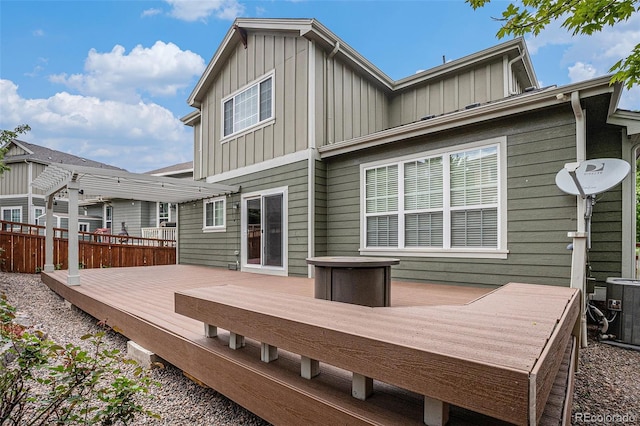 3389 Willowrun Dr, Castle Rock, CO 80109 - back of house with board and batten siding, a deck, and central AC