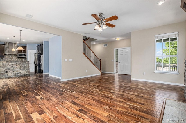 3389 Willowrun Dr, Castle Rock, CO 80109 - unfurnished living room with dark wood-type flooring, ceiling fan, stairway, baseboards, and recessed lighting