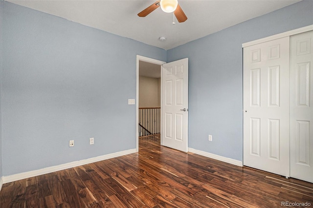 3389 Willowrun Dr, Castle Rock, CO 80109 - unfurnished bedroom with baseboards, dark wood finished floors, a closet, and ceiling fan
