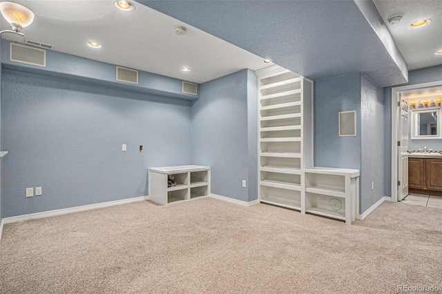 3389 Willowrun Dr, Castle Rock, CO 80109 - finished basement with carpet flooring, a sink, baseboards, and recessed lighting