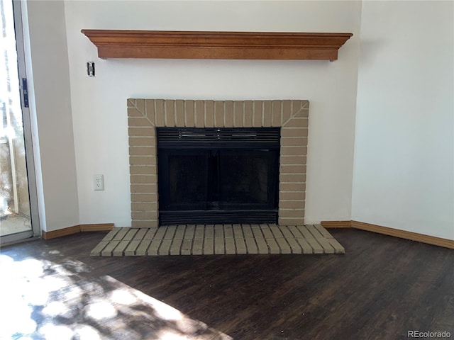 details with wood-type flooring and a brick fireplace