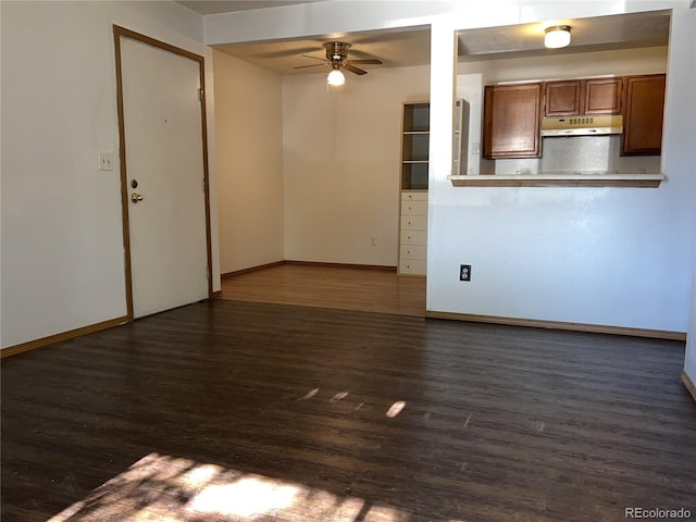 unfurnished living room featuring ceiling fan and dark hardwood / wood-style floors