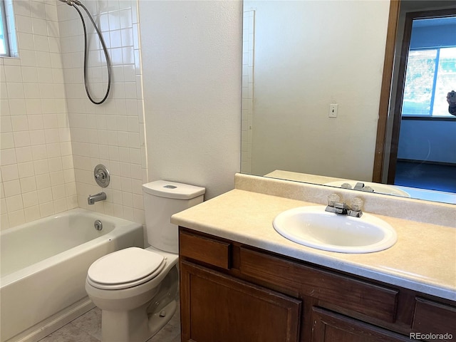 full bathroom featuring vanity, tiled shower / bath combo, toilet, and tile patterned flooring