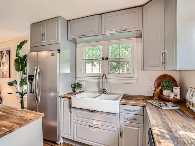 2329 S Gilpin St, Denver, CO 80210 - kitchen with stainless steel fridge, butcher block counters, and gray cabinets
