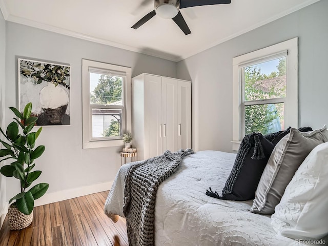 2329 S Gilpin St, Denver, CO 80210 - bedroom with wood finished floors, multiple windows, crown molding, and ceiling fan