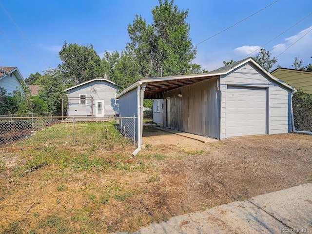 2329 S Gilpin St, Denver, CO 80210 - garage featuring driveway and a detached garage