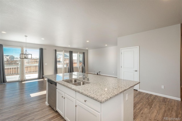 kitchen with dishwasher, a kitchen island with sink, dark wood-type flooring, sink, and white cabinetry