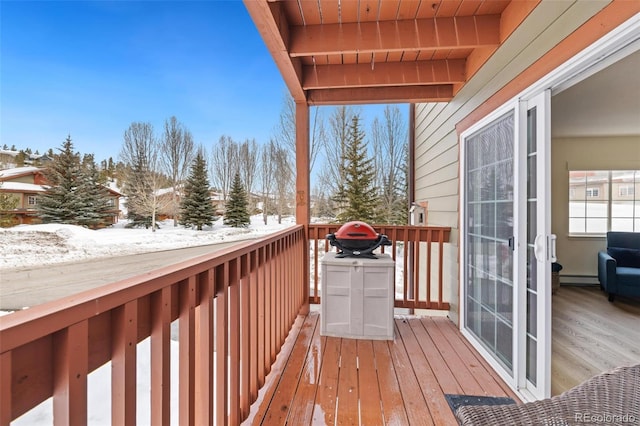 view of wooden balcony with a baseboard radiator and a wooden deck