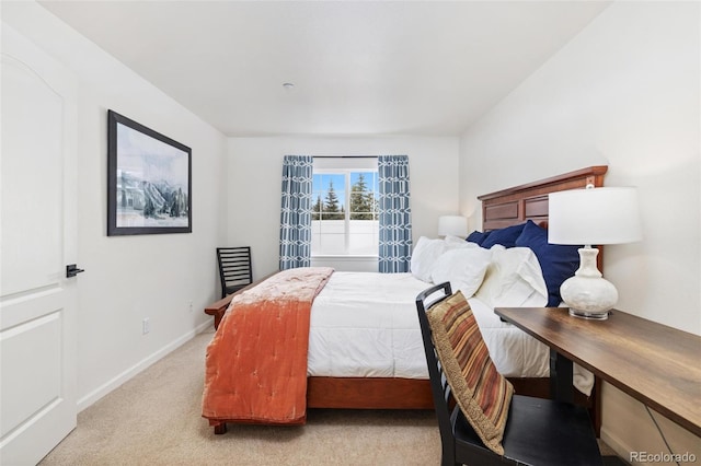 bedroom featuring light carpet and baseboards