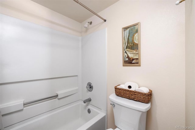 bathroom featuring shower / bathing tub combination and toilet