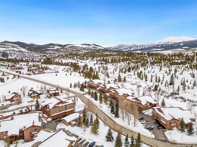 snowy aerial view with a mountain view