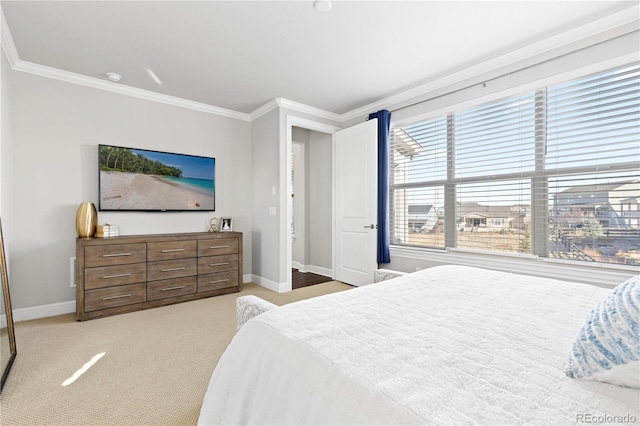 bedroom featuring baseboards, ornamental molding, and carpet flooring