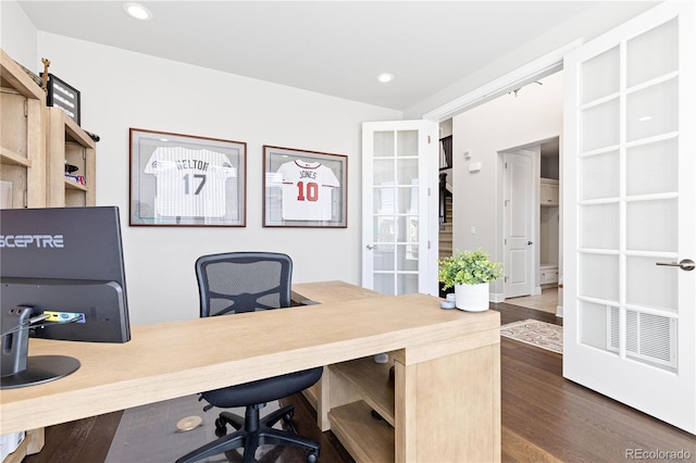 office with dark wood finished floors and recessed lighting