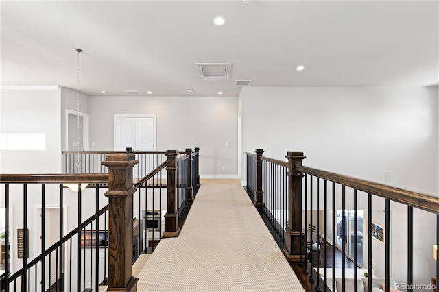 corridor with carpet, visible vents, baseboards, recessed lighting, and an upstairs landing