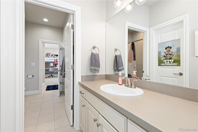 full bathroom featuring baseboards, vanity, and tile patterned flooring